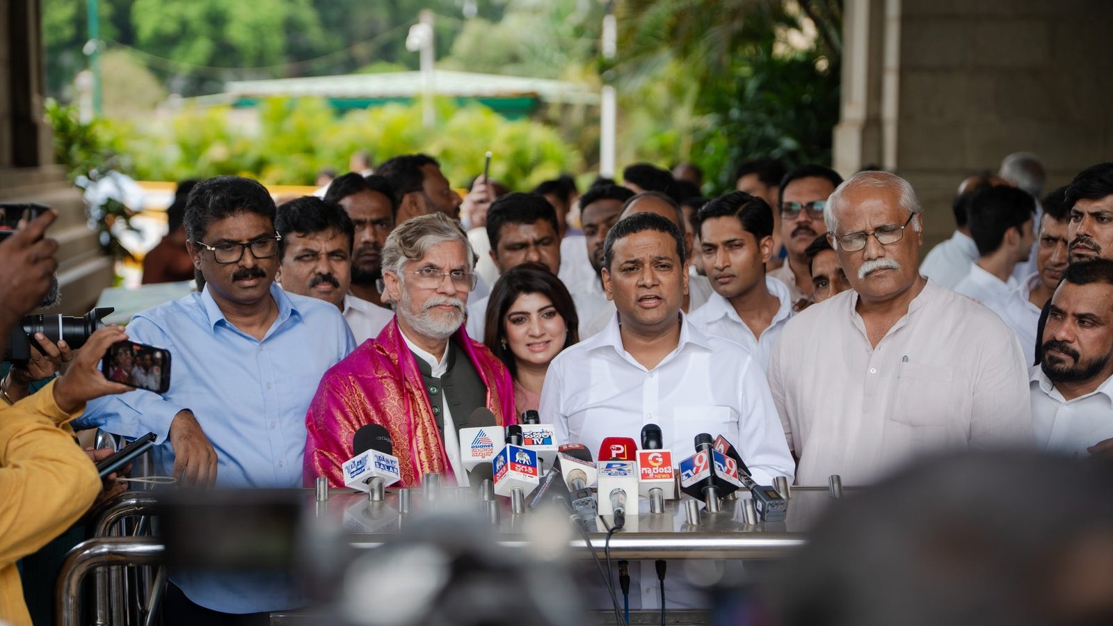 Mansoor Ali Khan speaking to reporters at a press interaction.