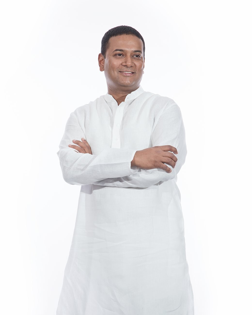 Mansoor Ali Khan in a white kurta, arms crossed.